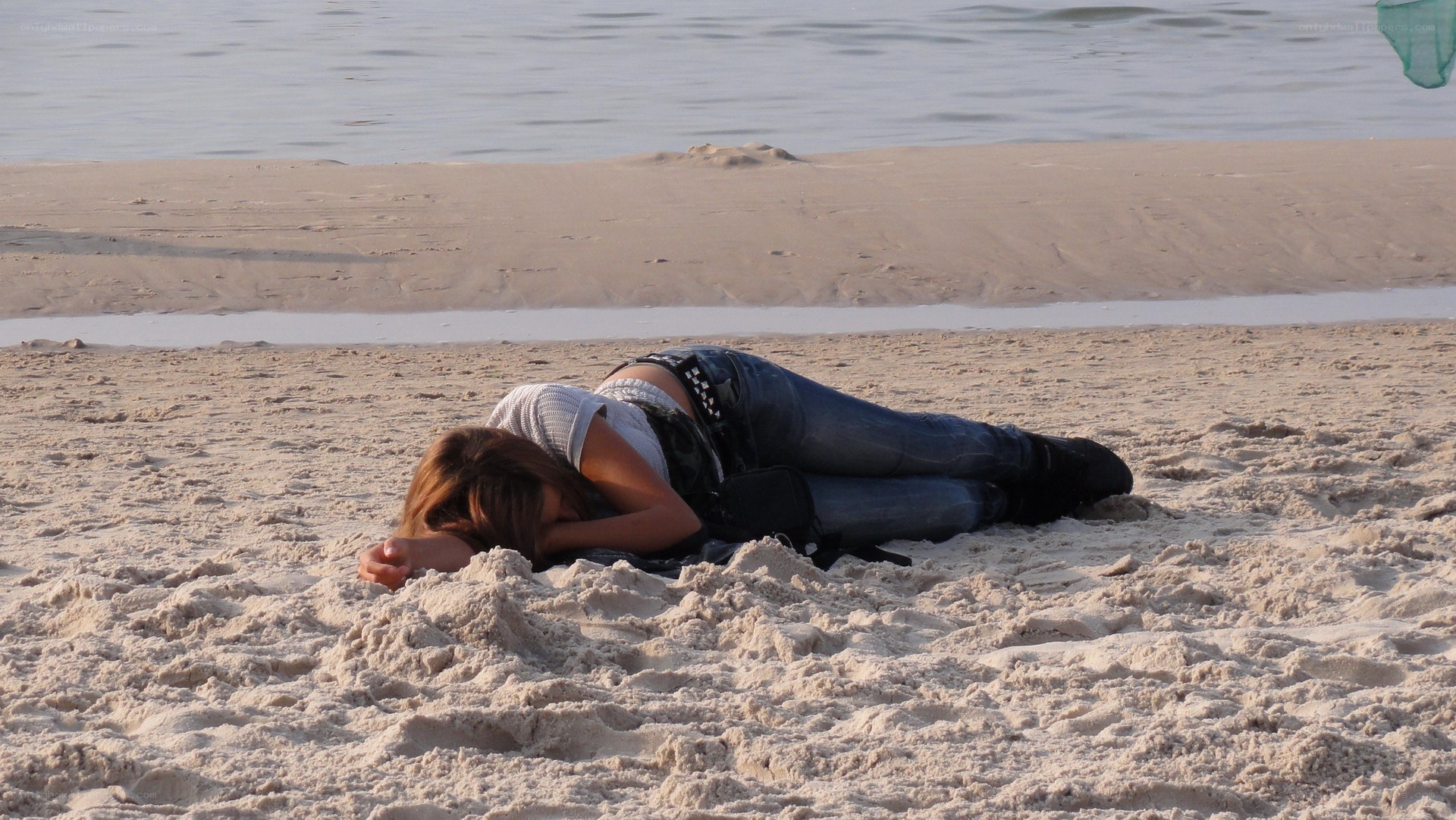 Person resting on beach