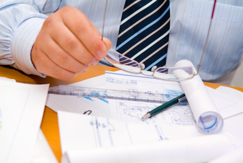 Person Reviewing Blueprints
