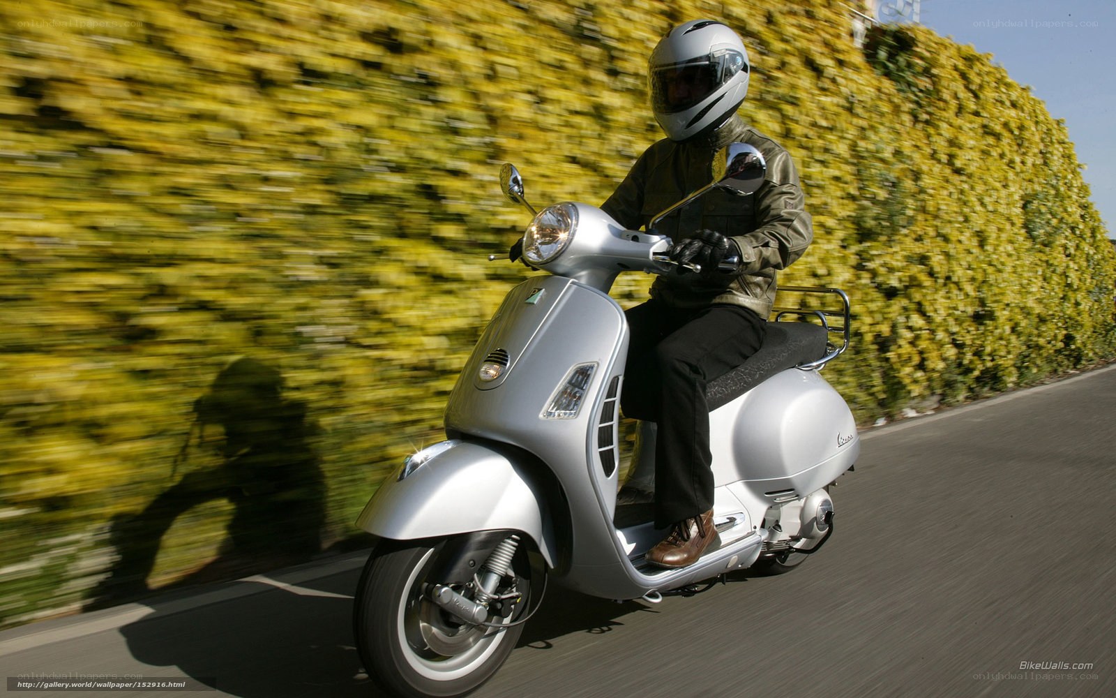 Person riding a silver scooter