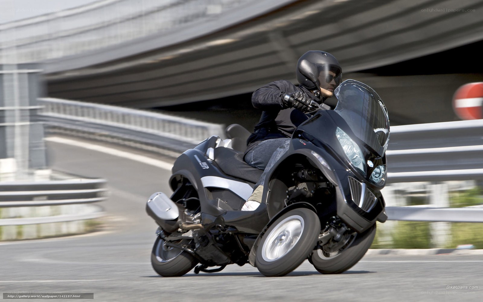 Person riding a three-wheeled motorcycle