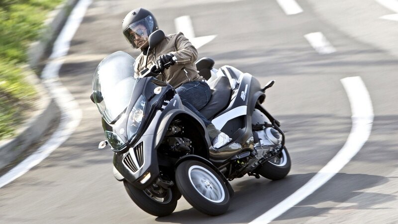 person riding a three-wheeled scooter