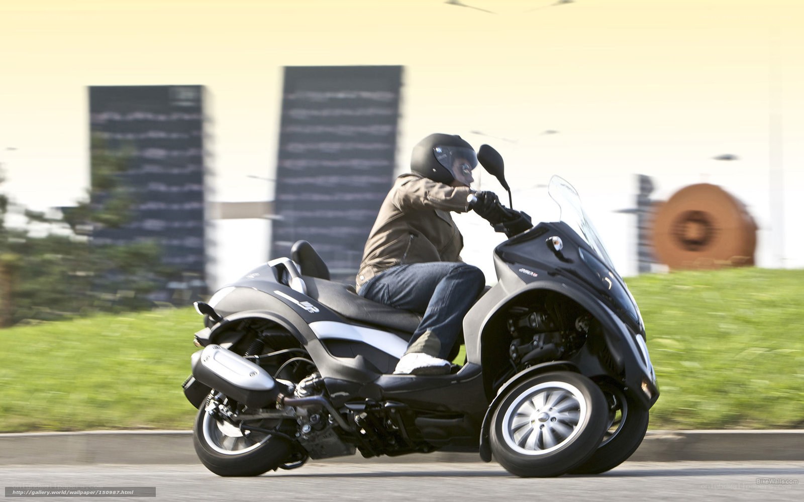 Person riding a three-wheeled scooter
