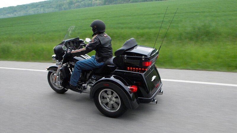 person riding a trike on road