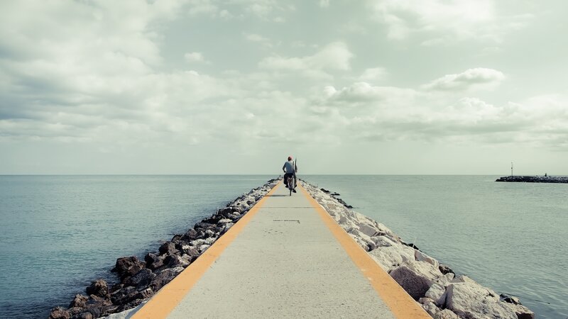 person riding bike on pier