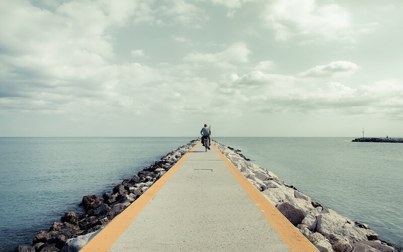 person riding bike on pier