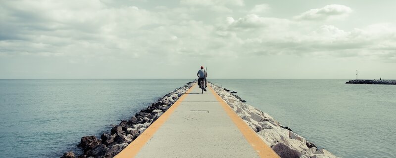 Person riding bike on pier