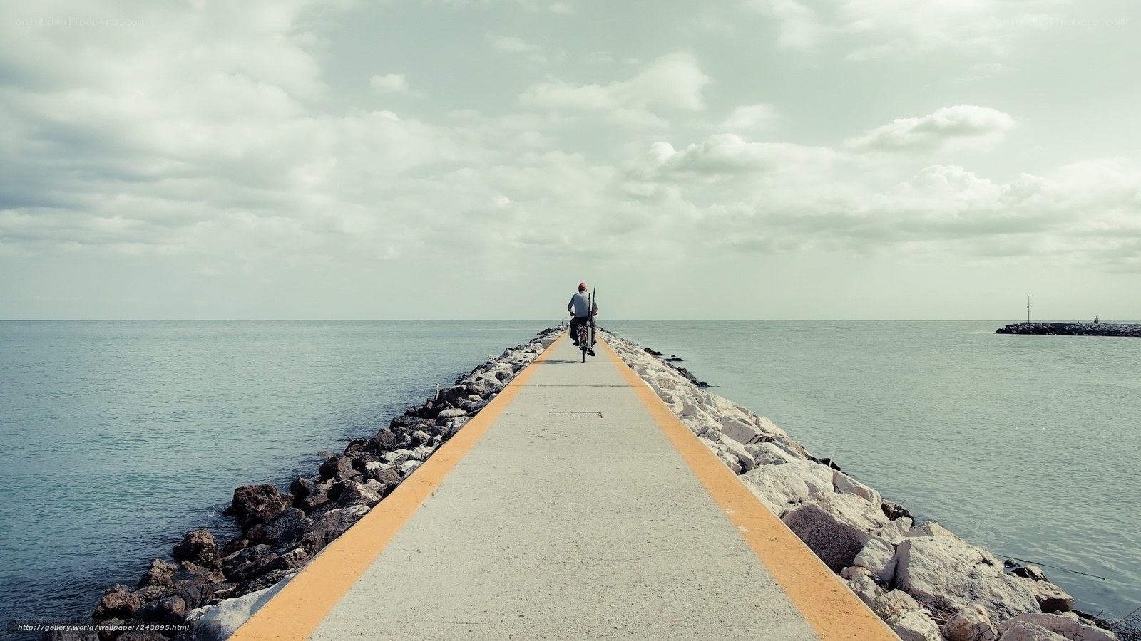 person riding bike on pier