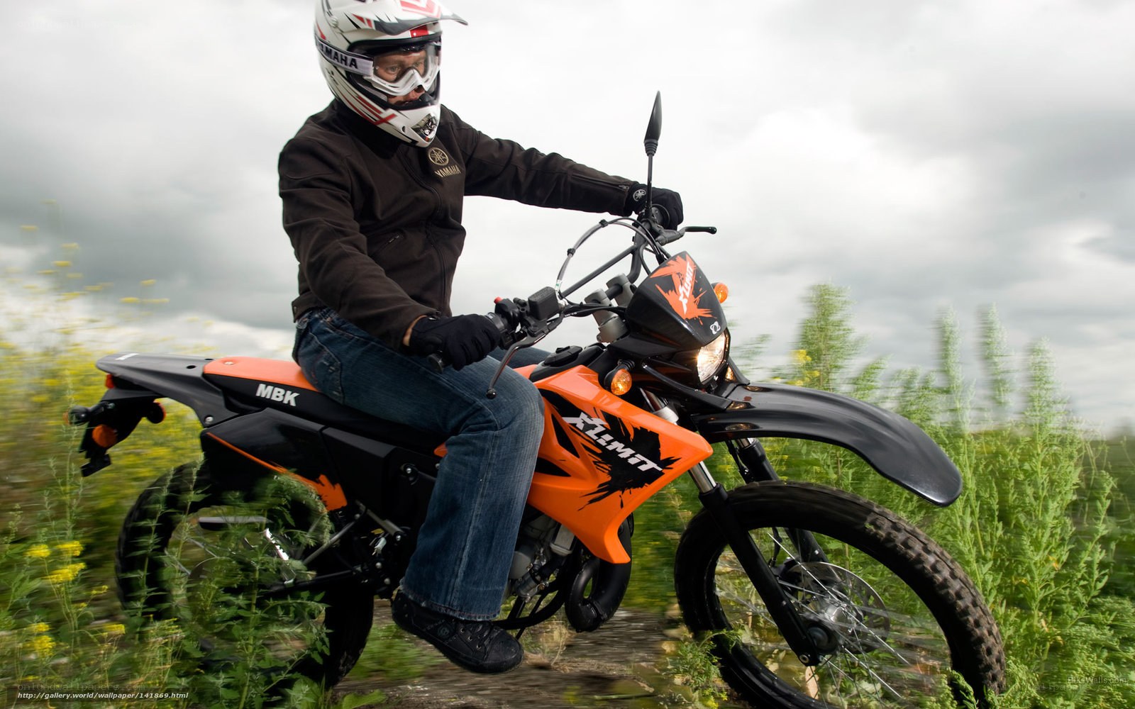 person riding orange dirt bike
