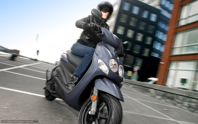 person riding scooter in city
