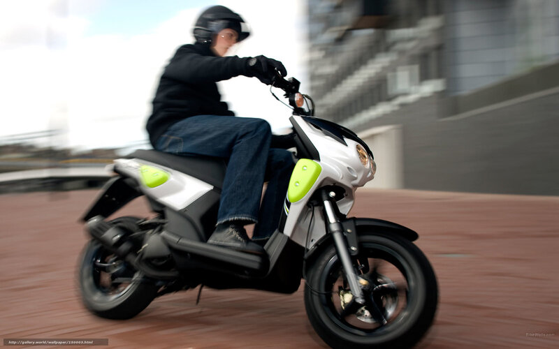 person riding scooter in city