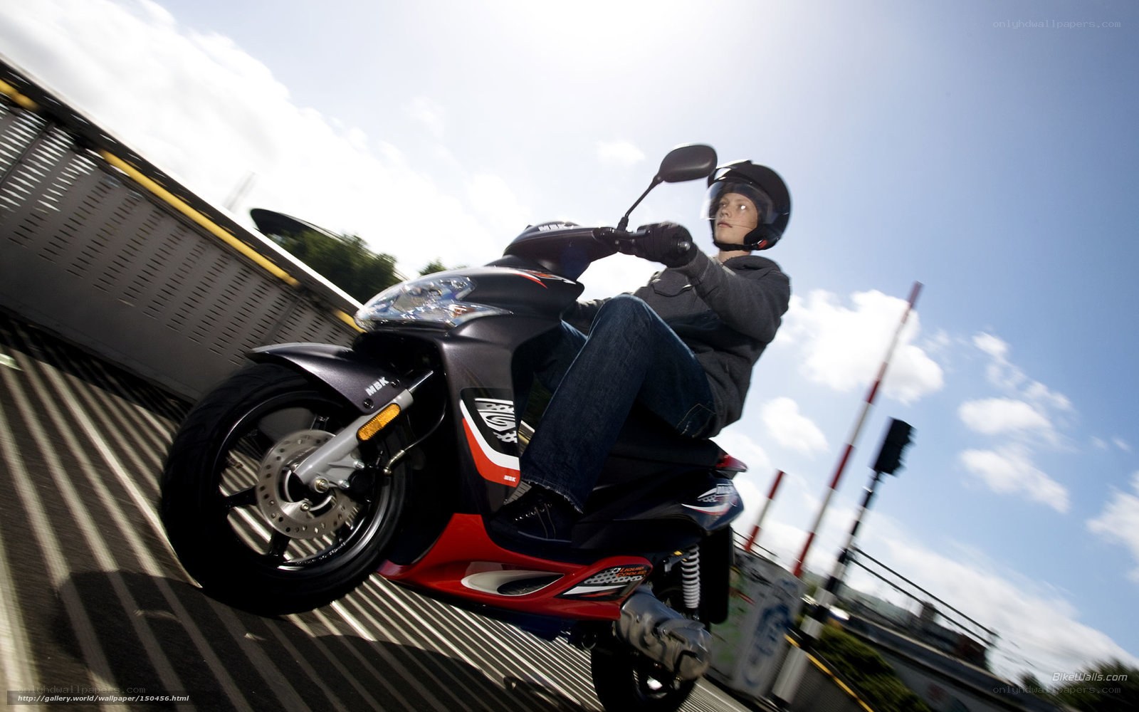 Person riding scooter on bridge