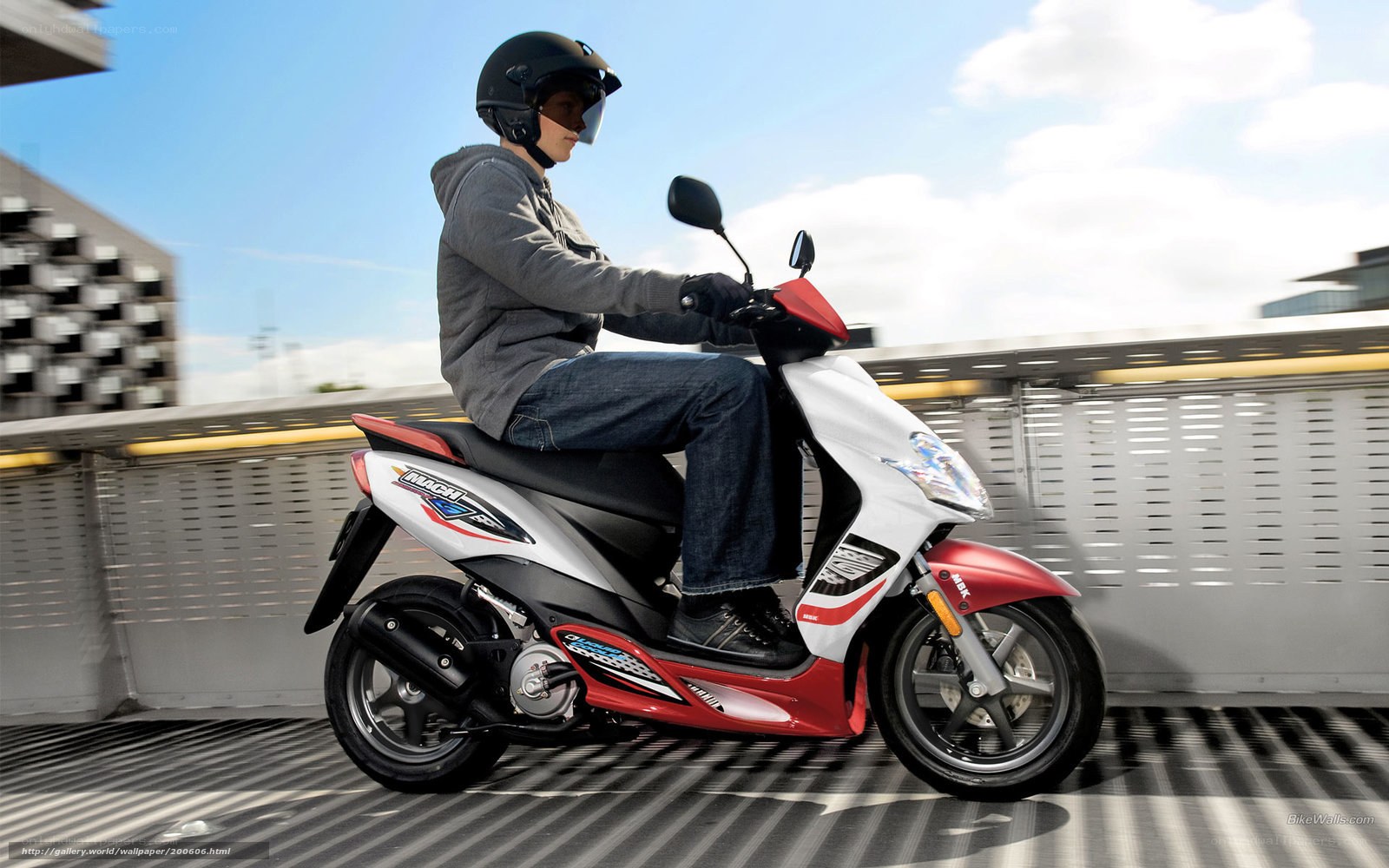 person riding scooter on bridge