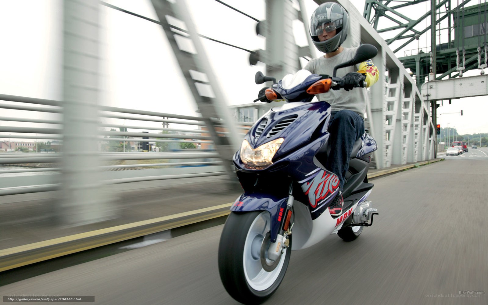 person riding scooter on bridge
