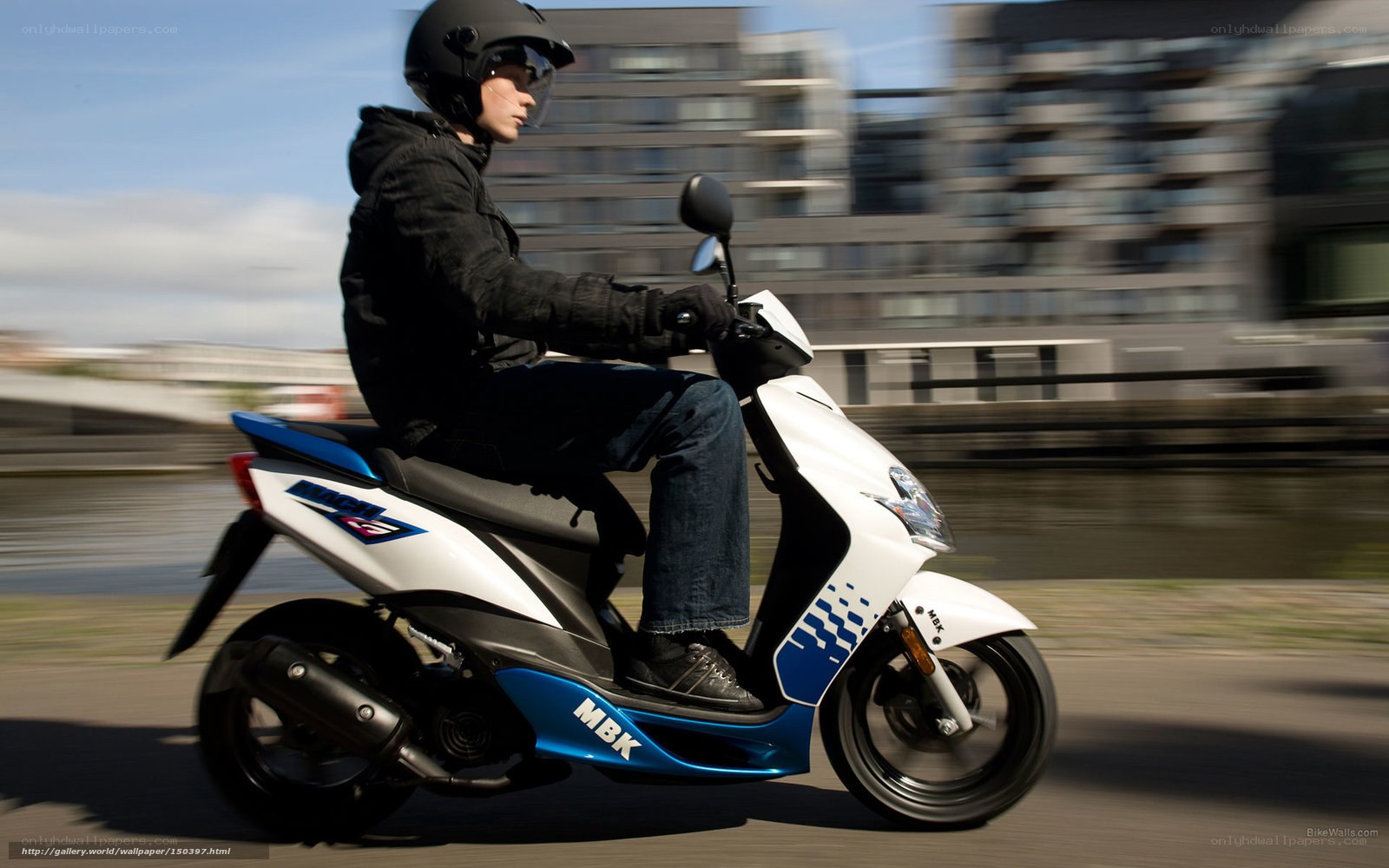 person riding scooter on city street