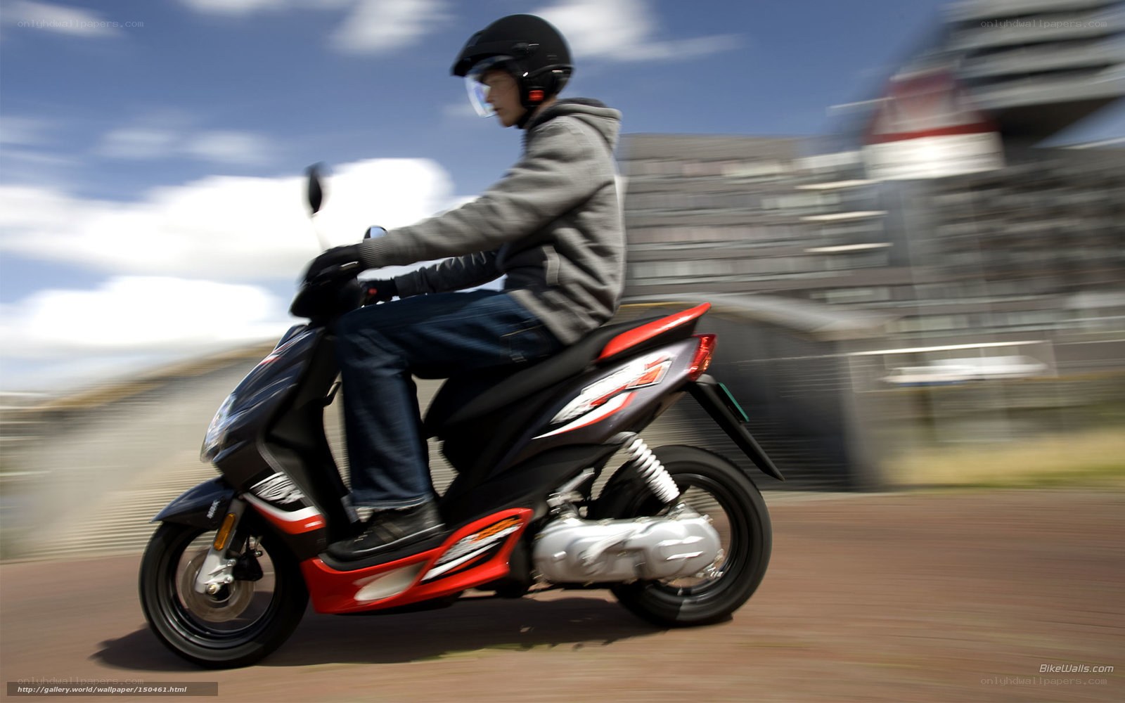 person riding scooter on city street