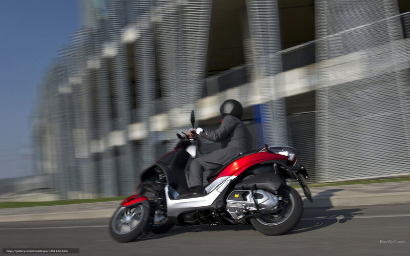 Person riding scooter on city street