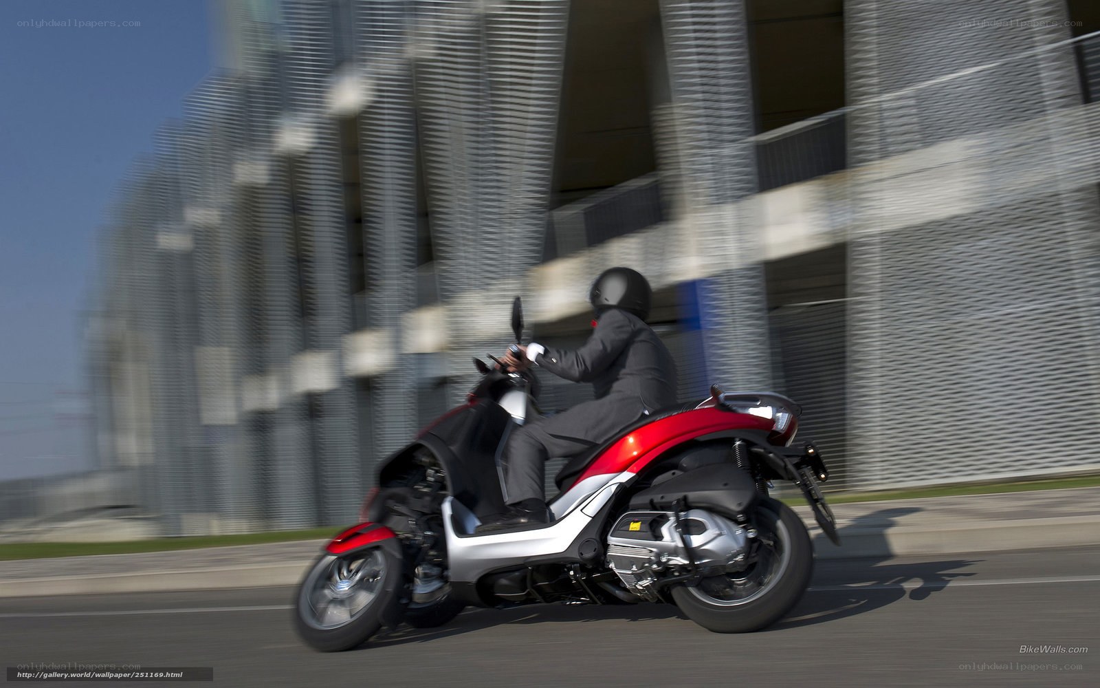 Person riding scooter on city street