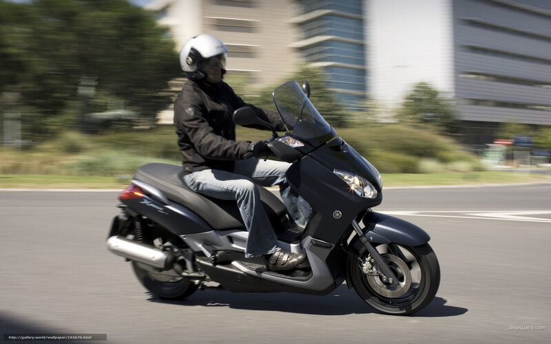 person riding scooter on road