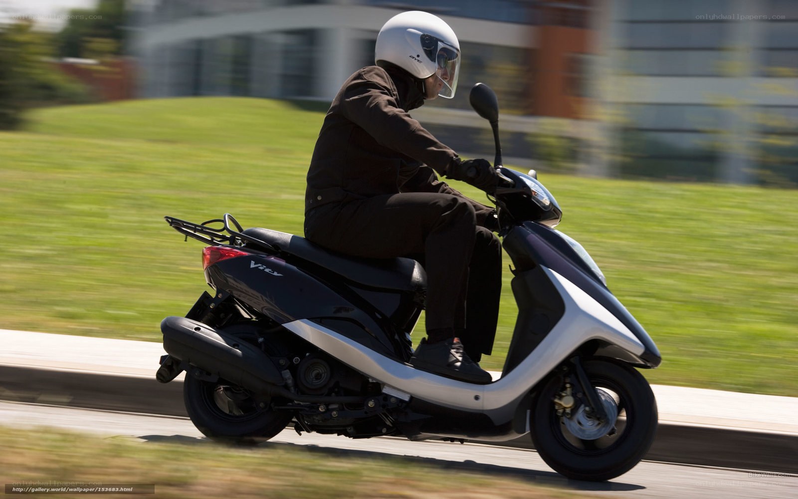 person riding scooter on road