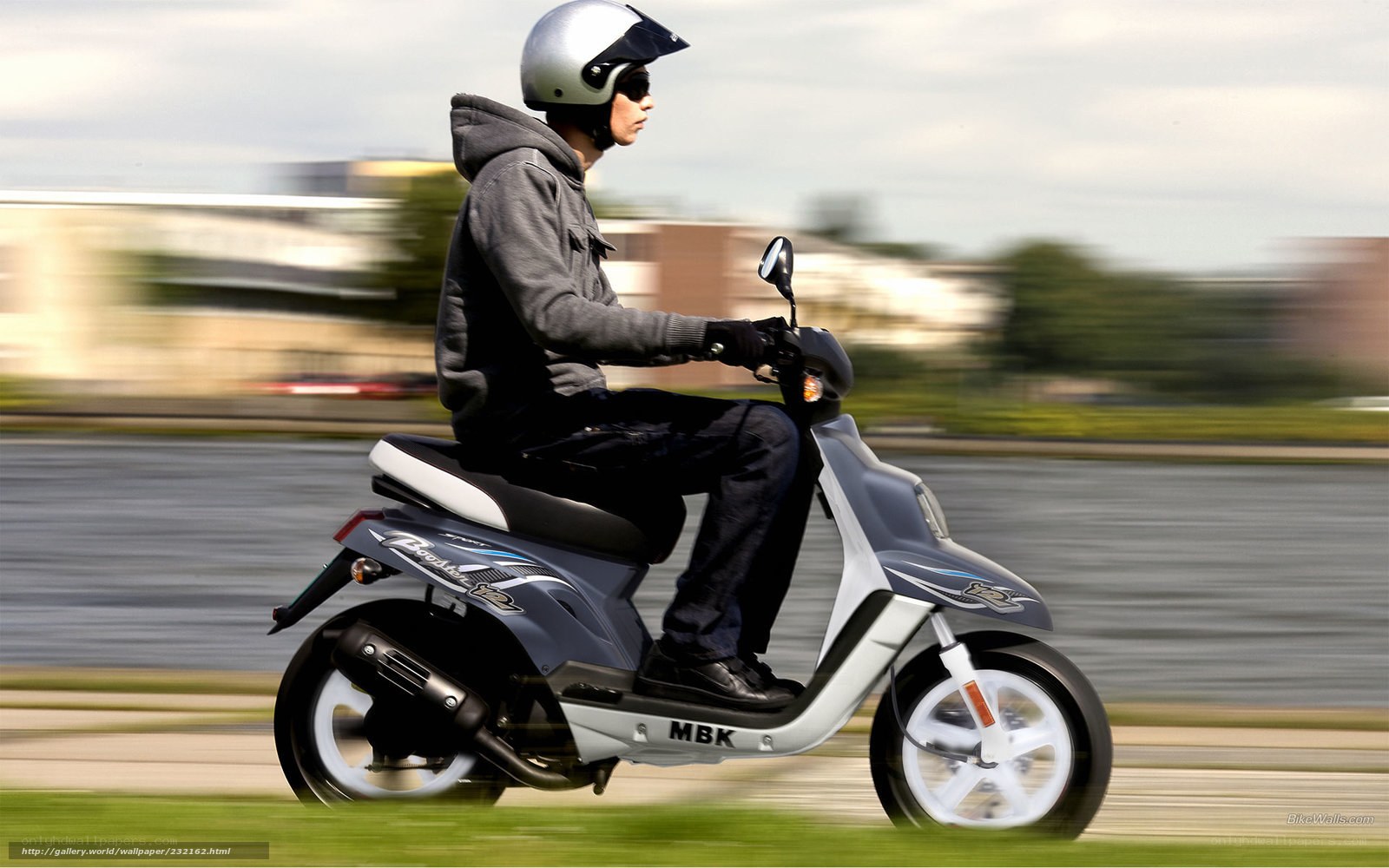 person riding scooter on road