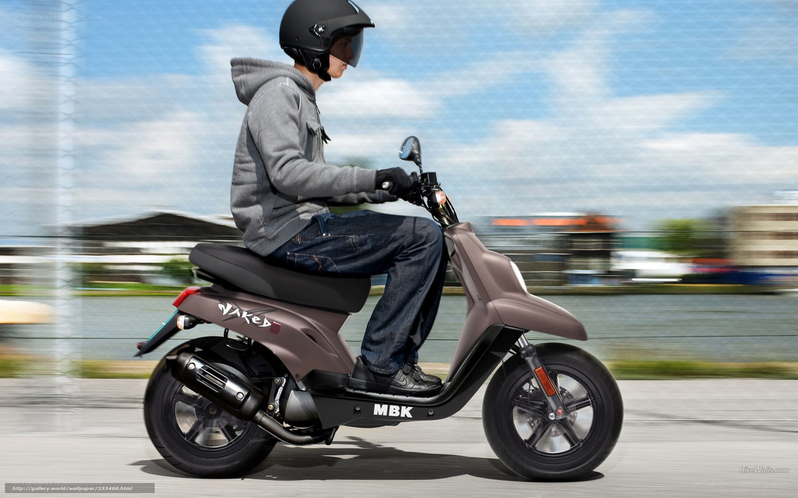 person riding scooter on road