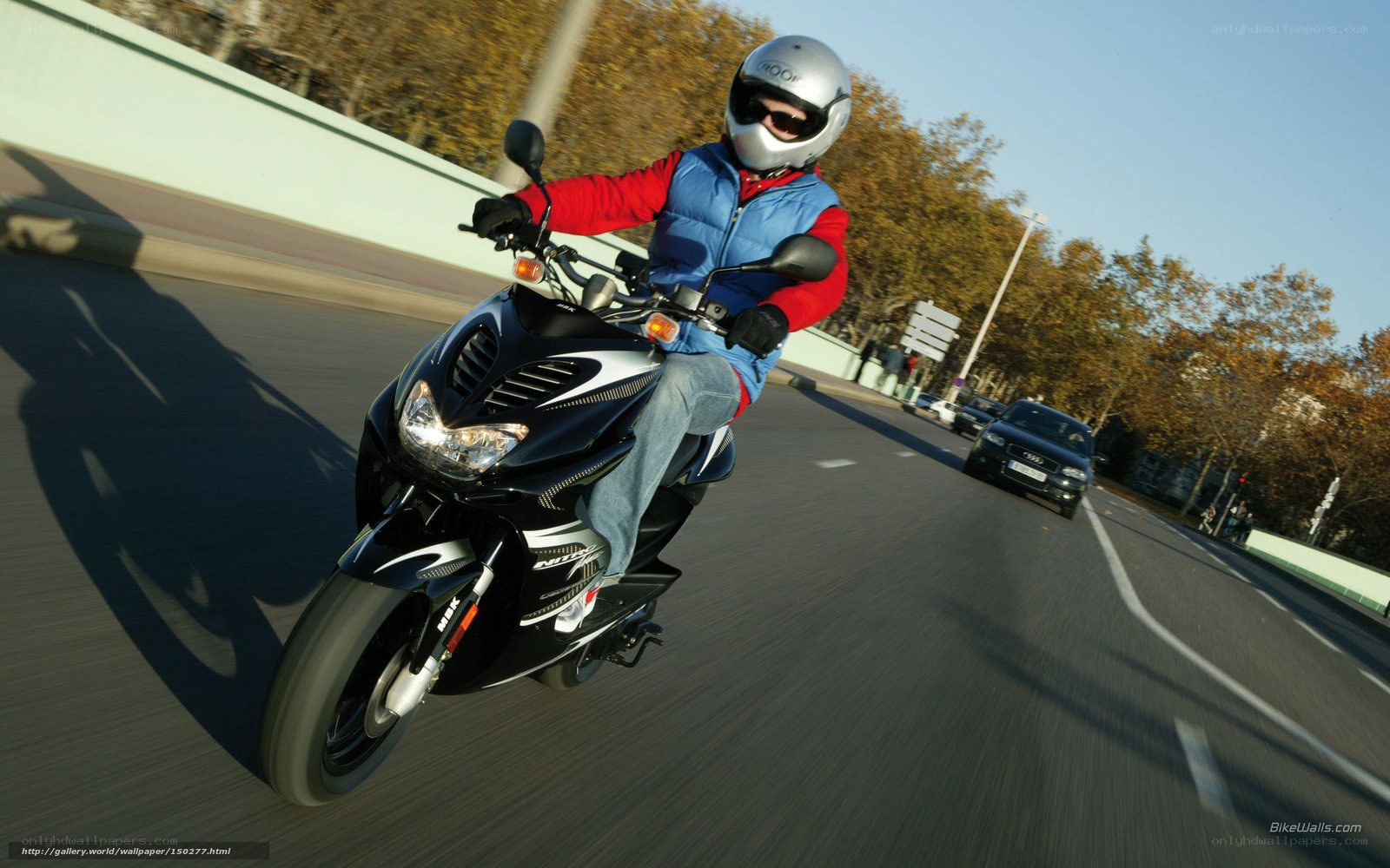 person riding scooter on road