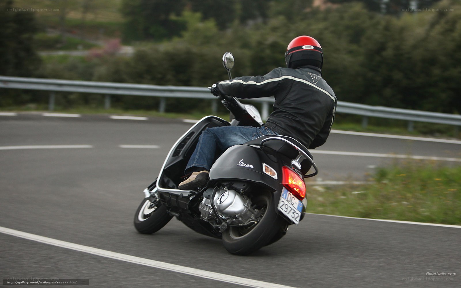 person riding scooter on road