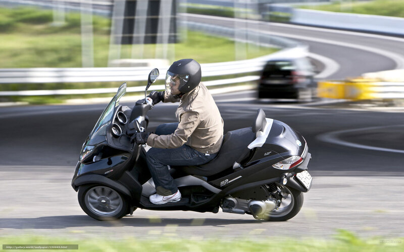 person riding scooter on track