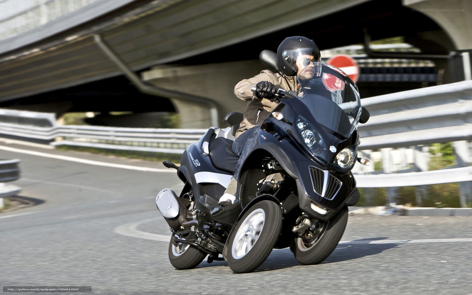 person riding three-wheeled motorcycle