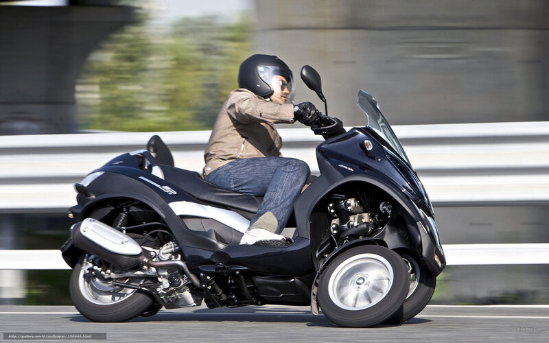 Person Riding Three-wheeled Scooter