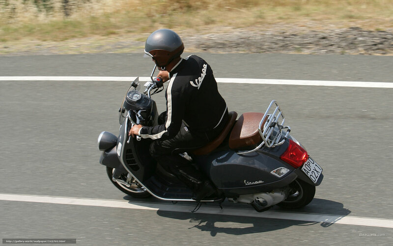 person riding vespa scooter