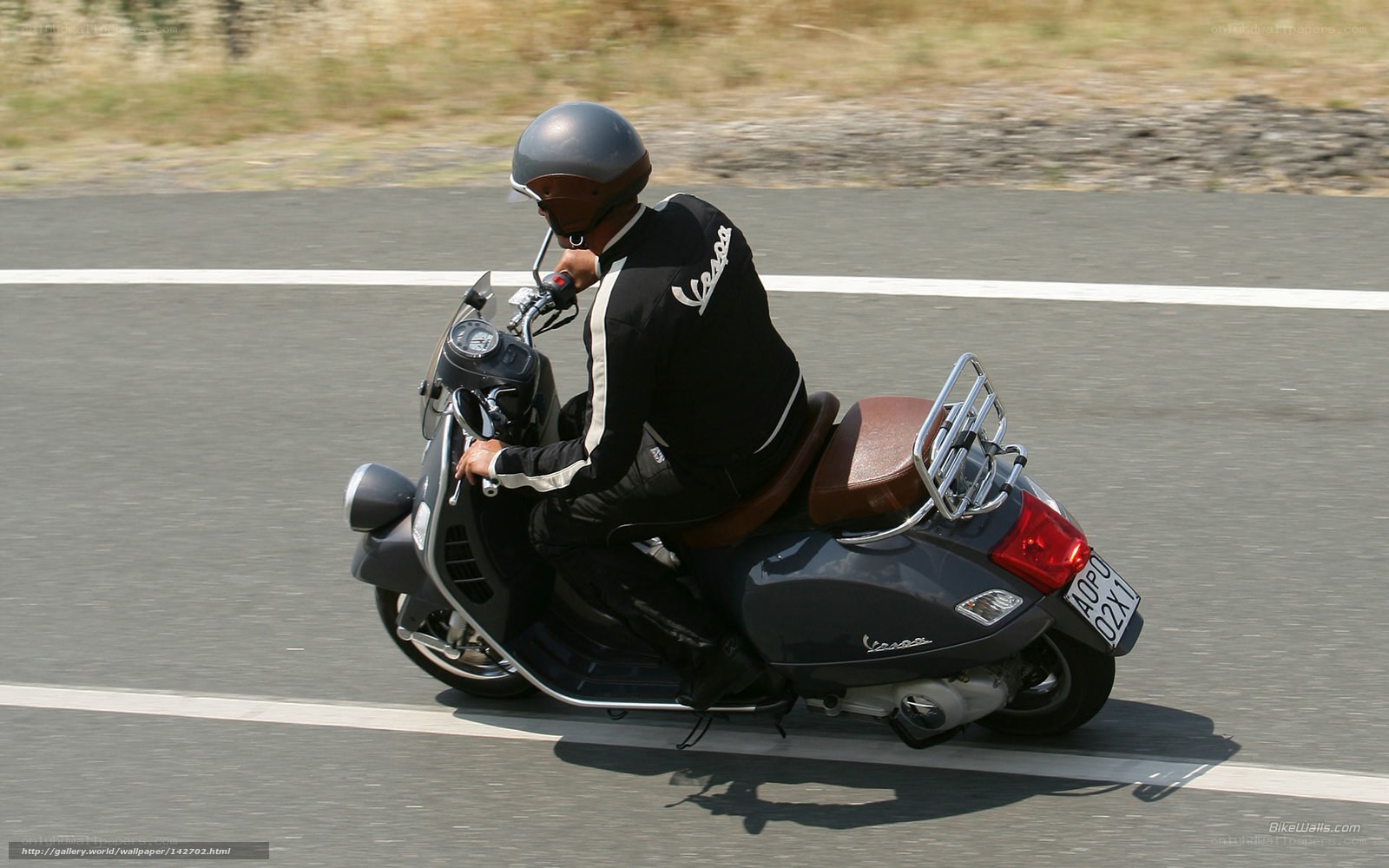 person riding vespa scooter
