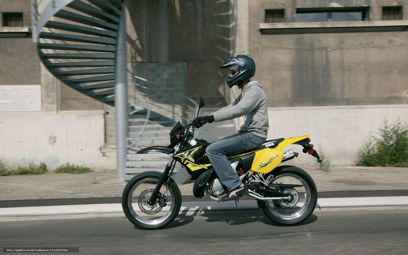 person riding yellow motorcycle