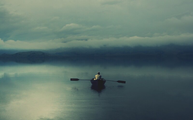 Person rowing a boat on calm water