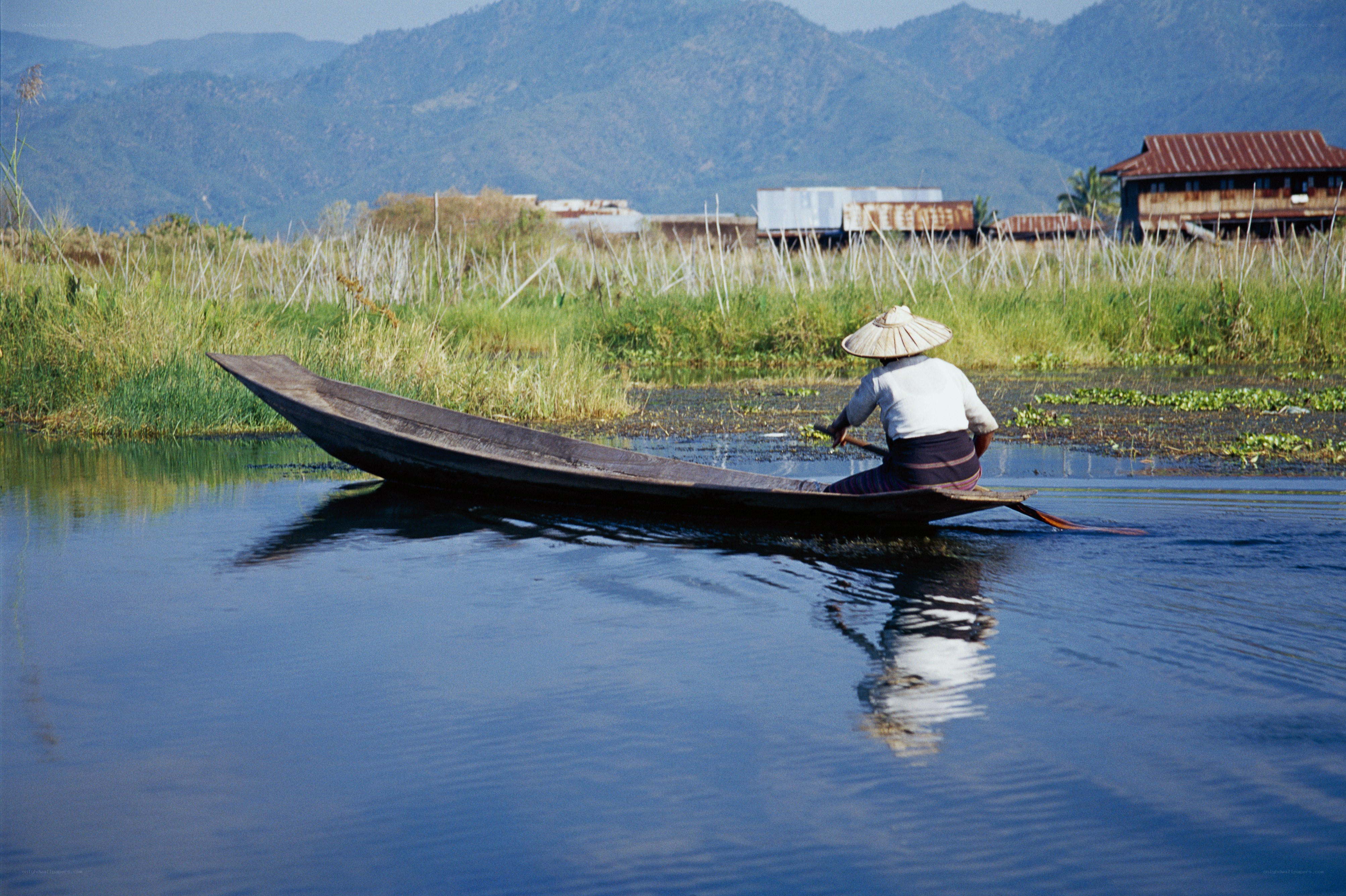 Person rowing boat on lake