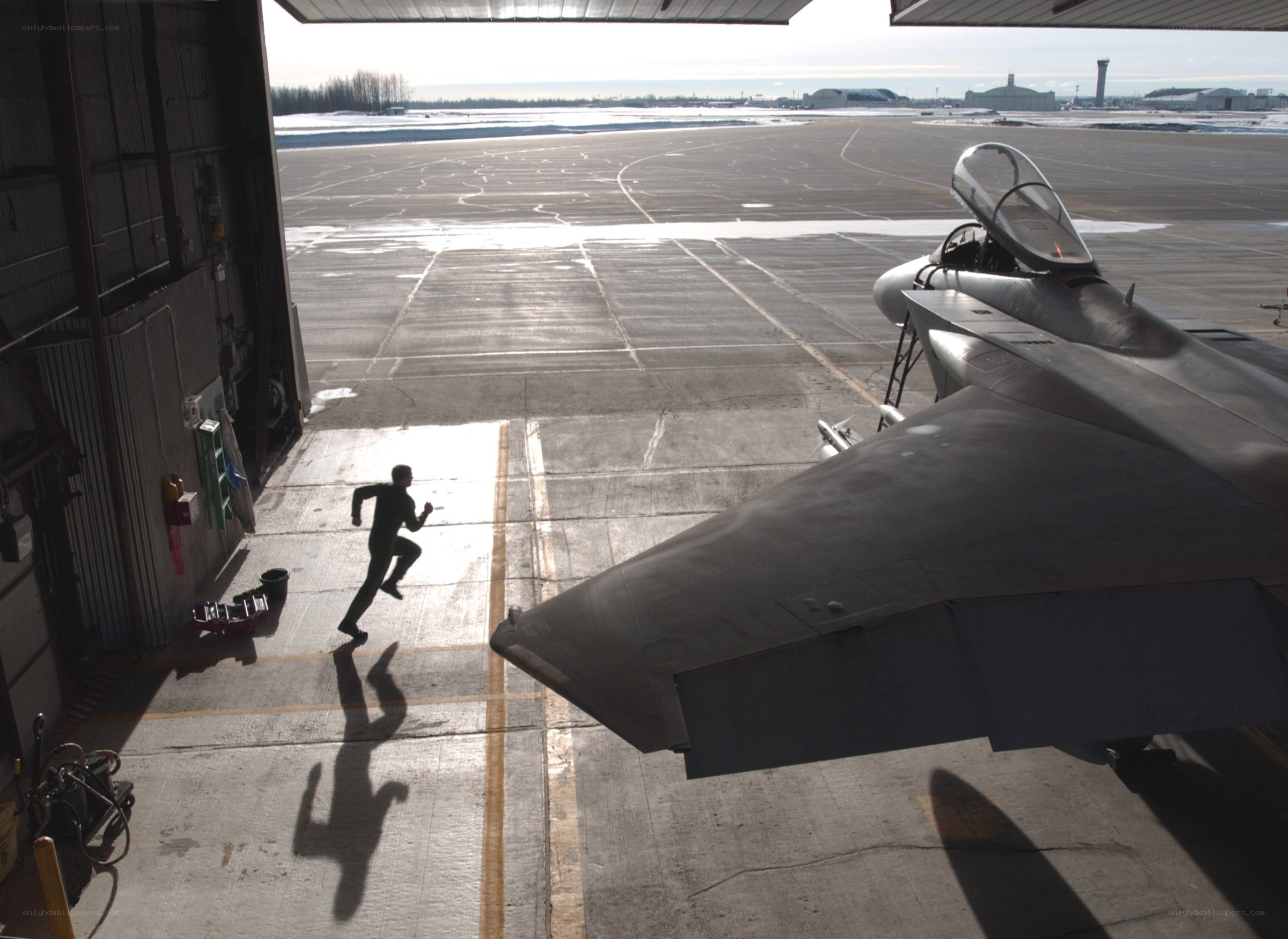Person running from hangar