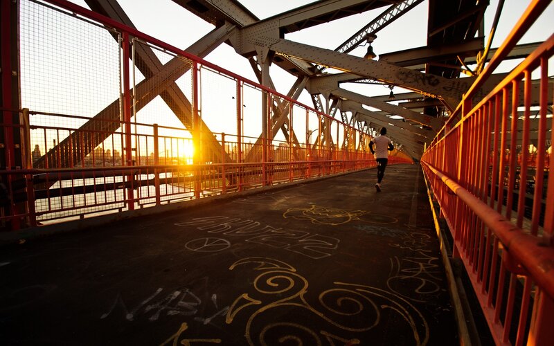 Person Running on Bridge