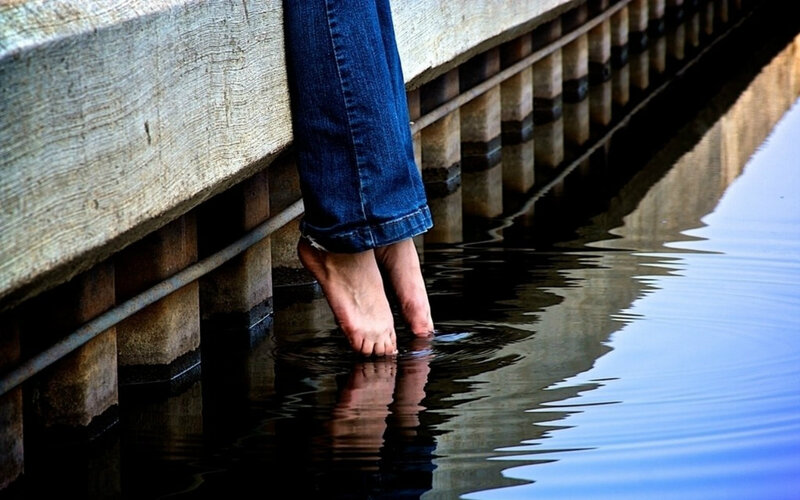 Person's Feet in Water
