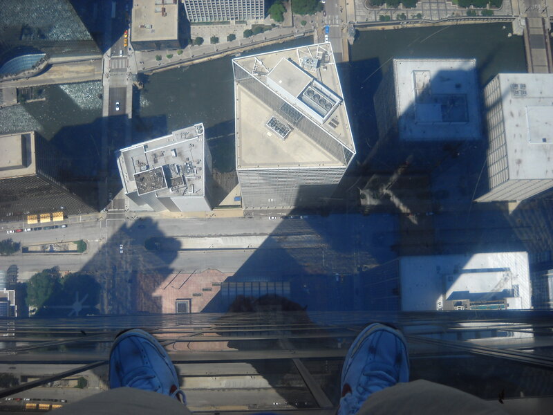 Person's Feet on Glass Floor