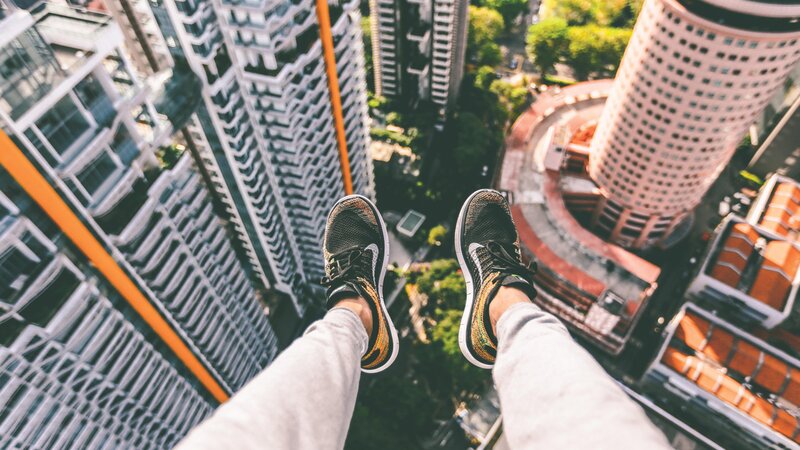 Person's Feet on High Building
