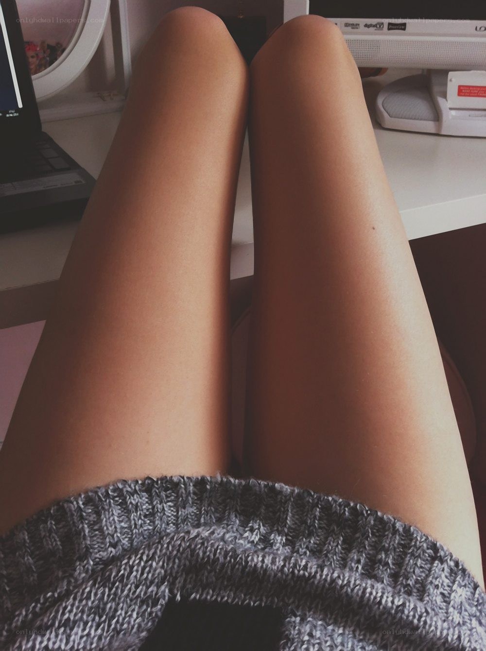 person's legs on desk