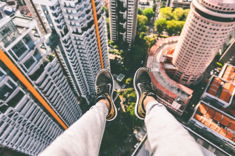 Person's Legs on High Ledge