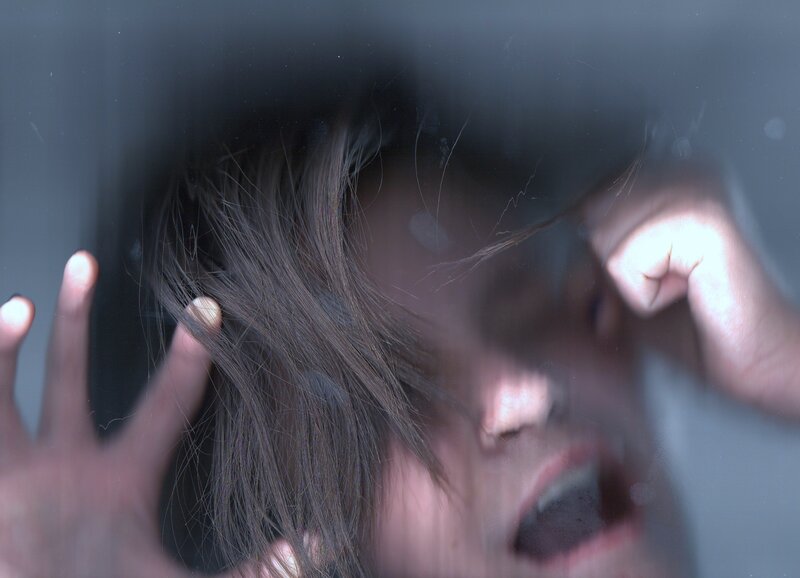 Person Screaming Behind Glass