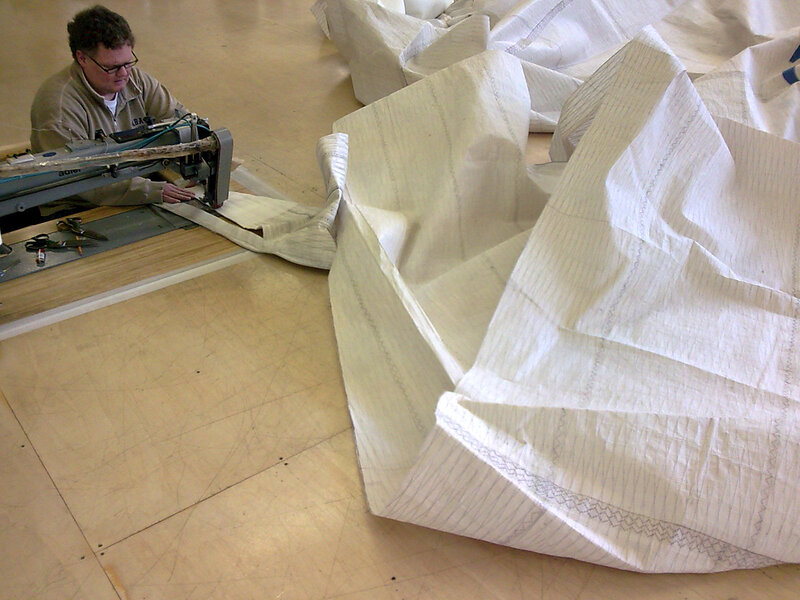 Person sewing large fabric piece