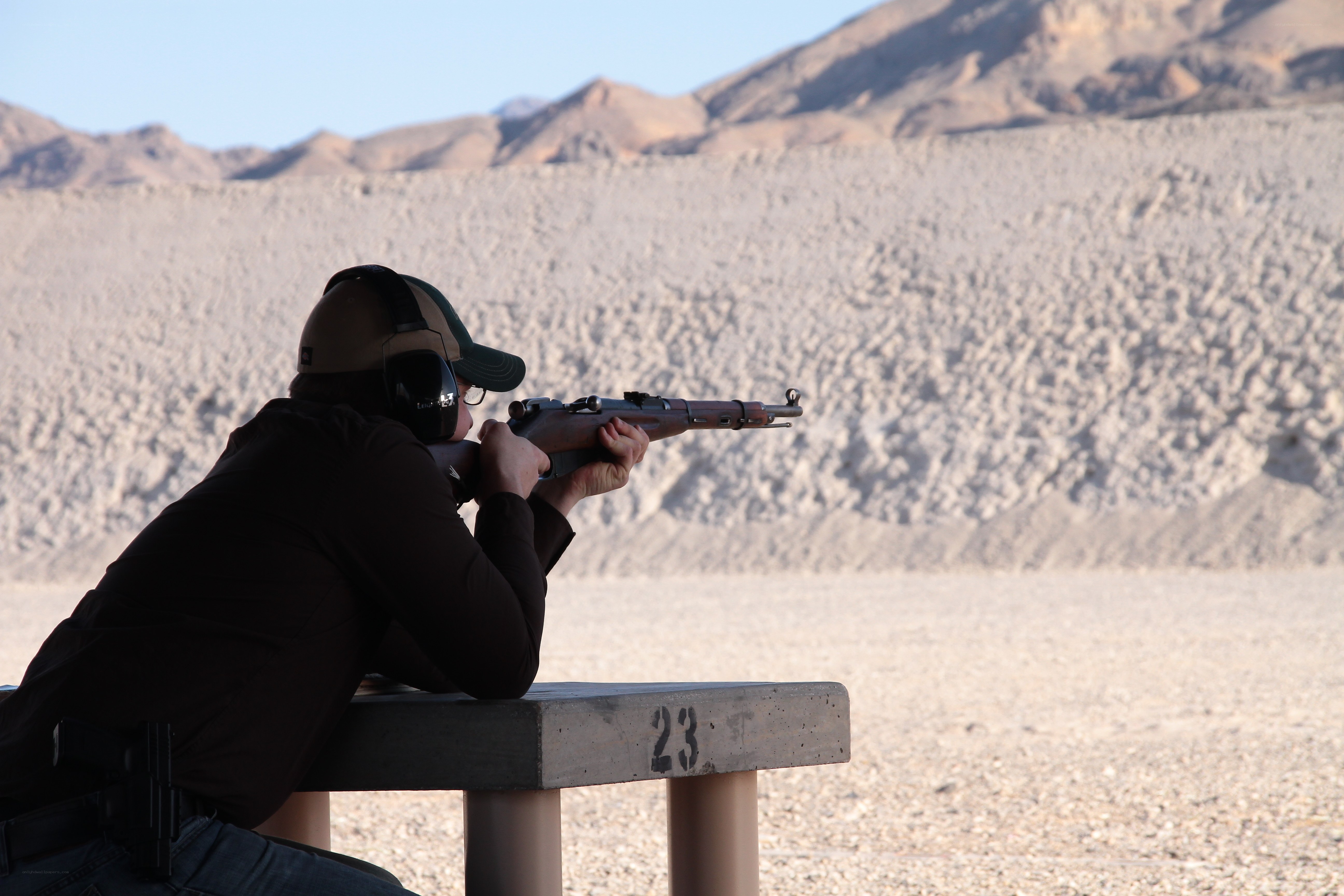 person shooting rifle at range
