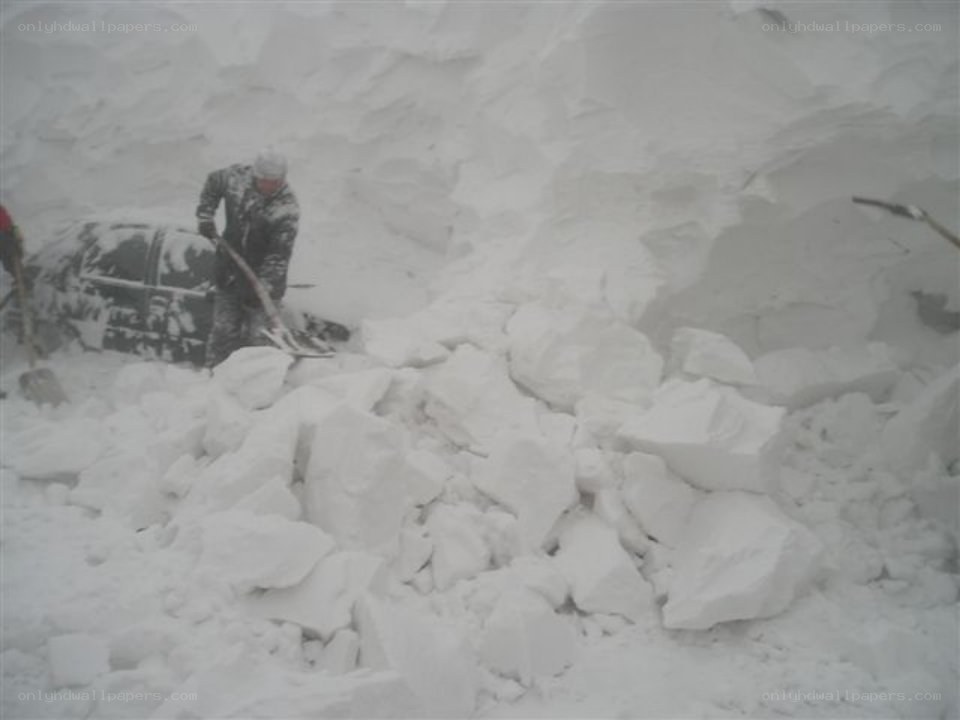 Person shoveling snow from car