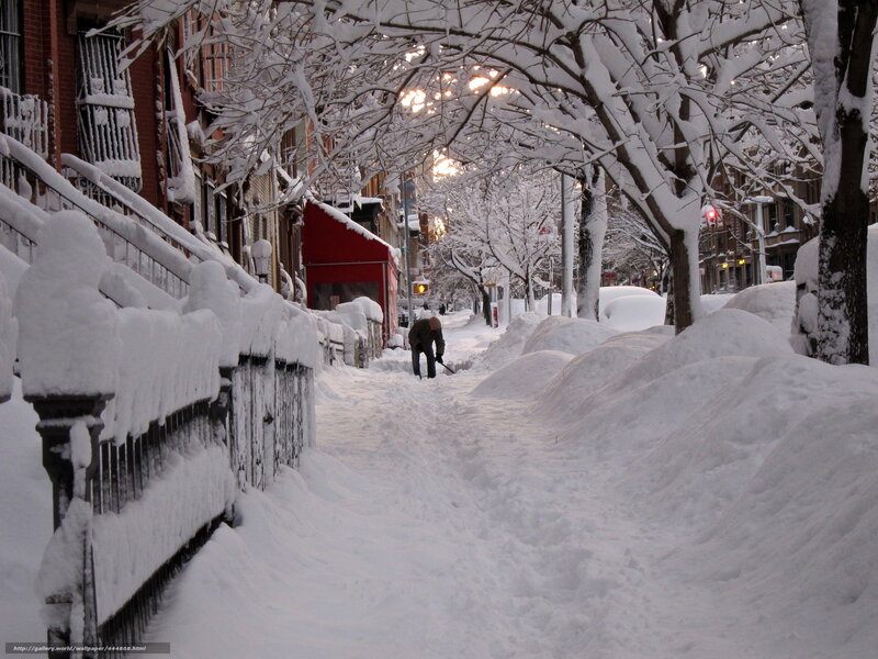 Person shoveling snow on a city street