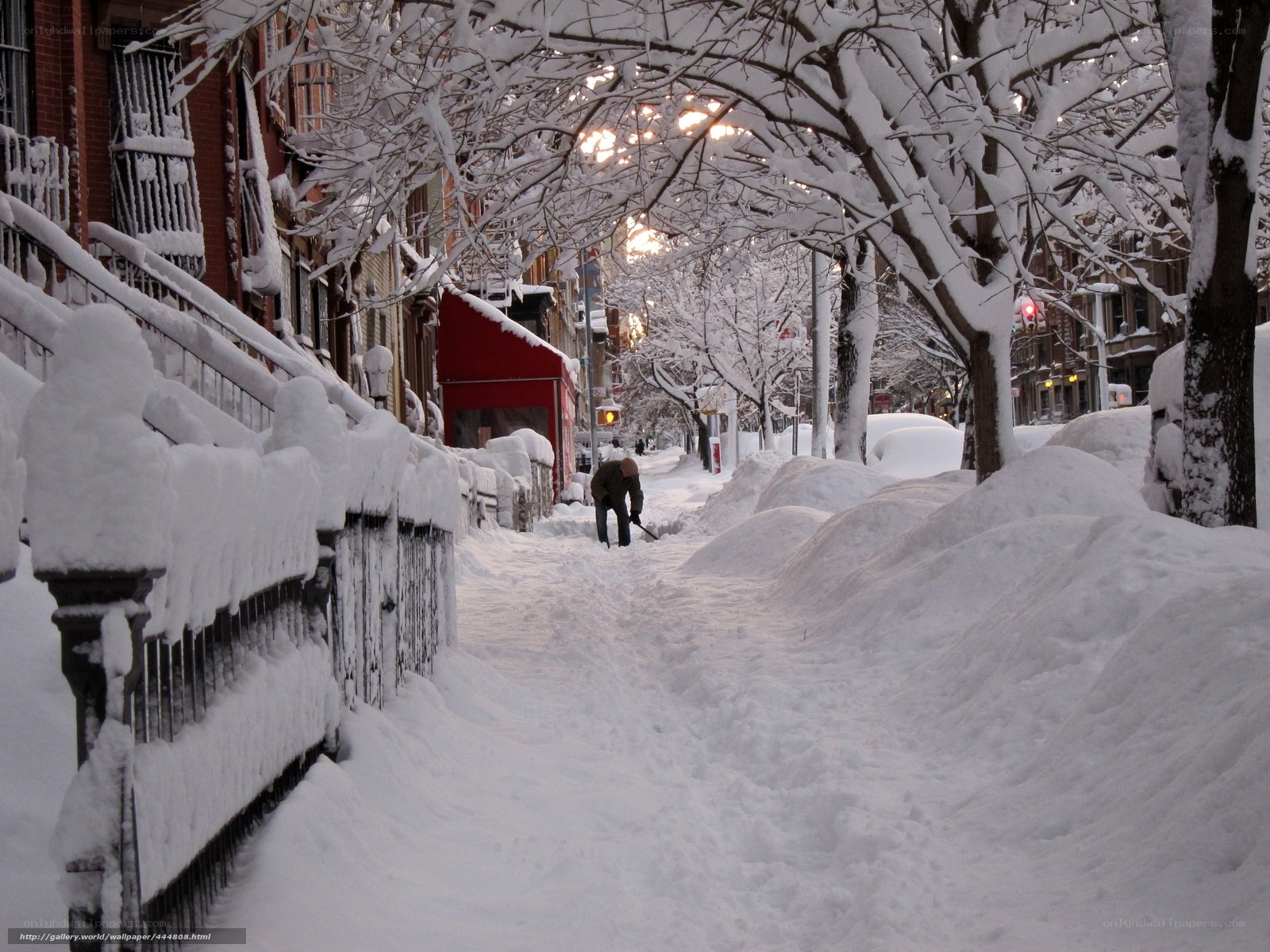 Person shoveling snow on a city street