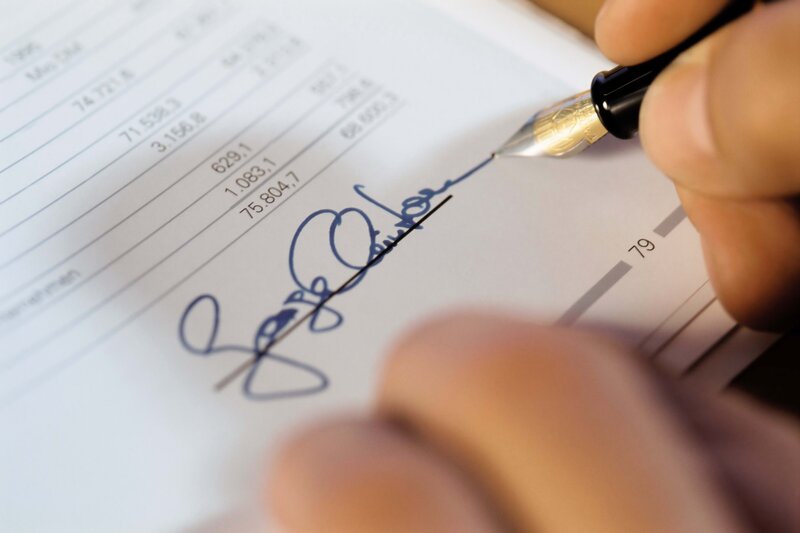 person signing a document