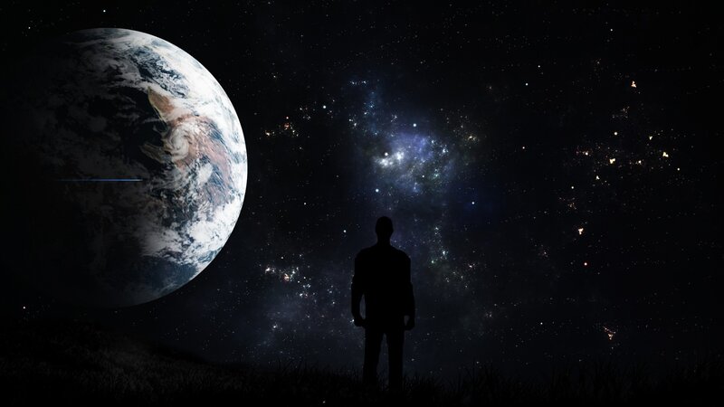 Person silhouetted against Earth and stars